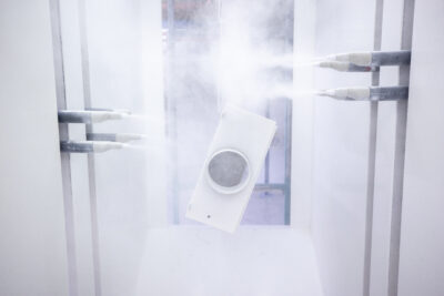 Shot of the powder coating robot, which is spraying one part white