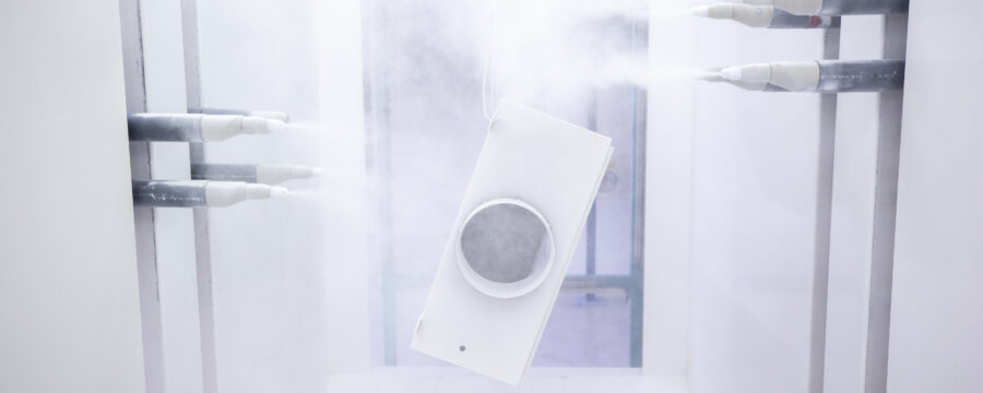 Shot of the powder coating robot, which is spraying one part white